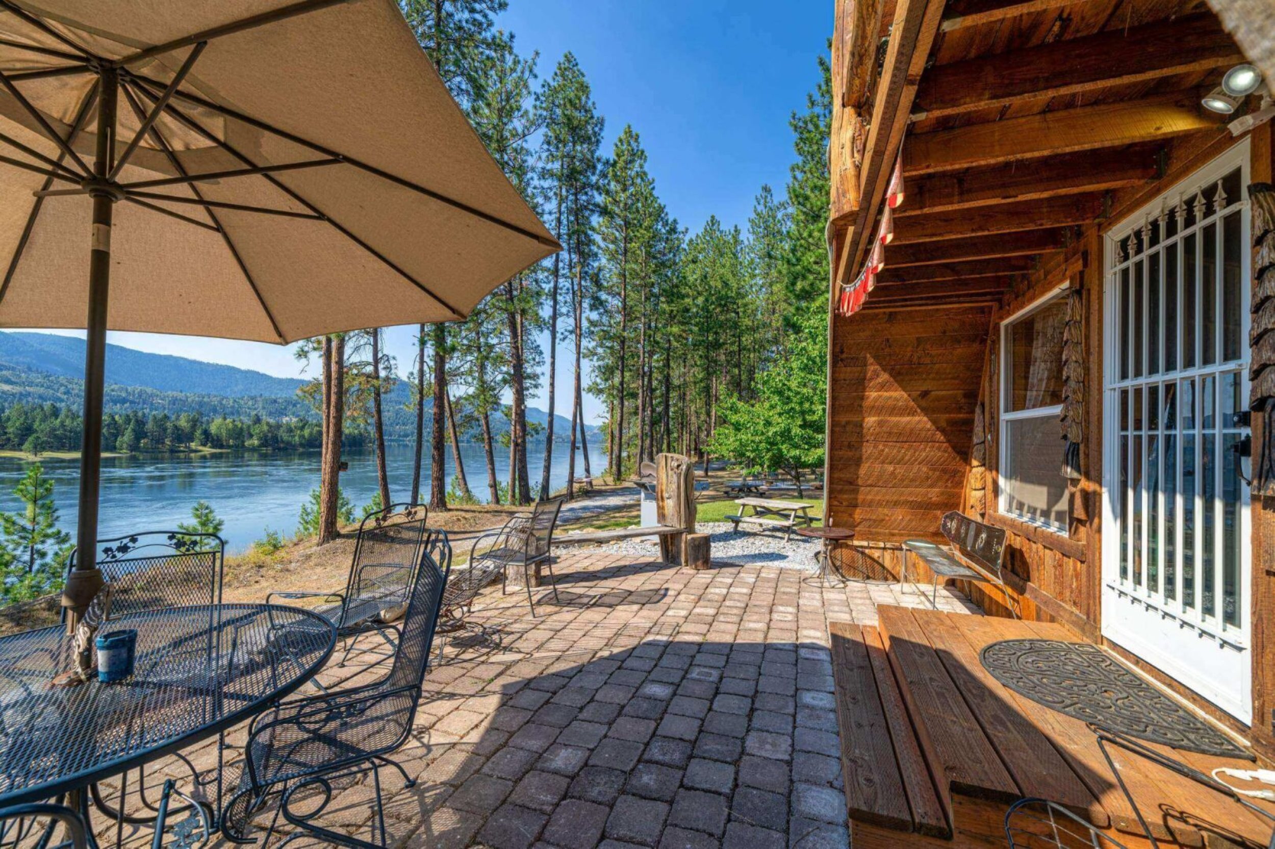 Cabin patio overlooking lake and forest.