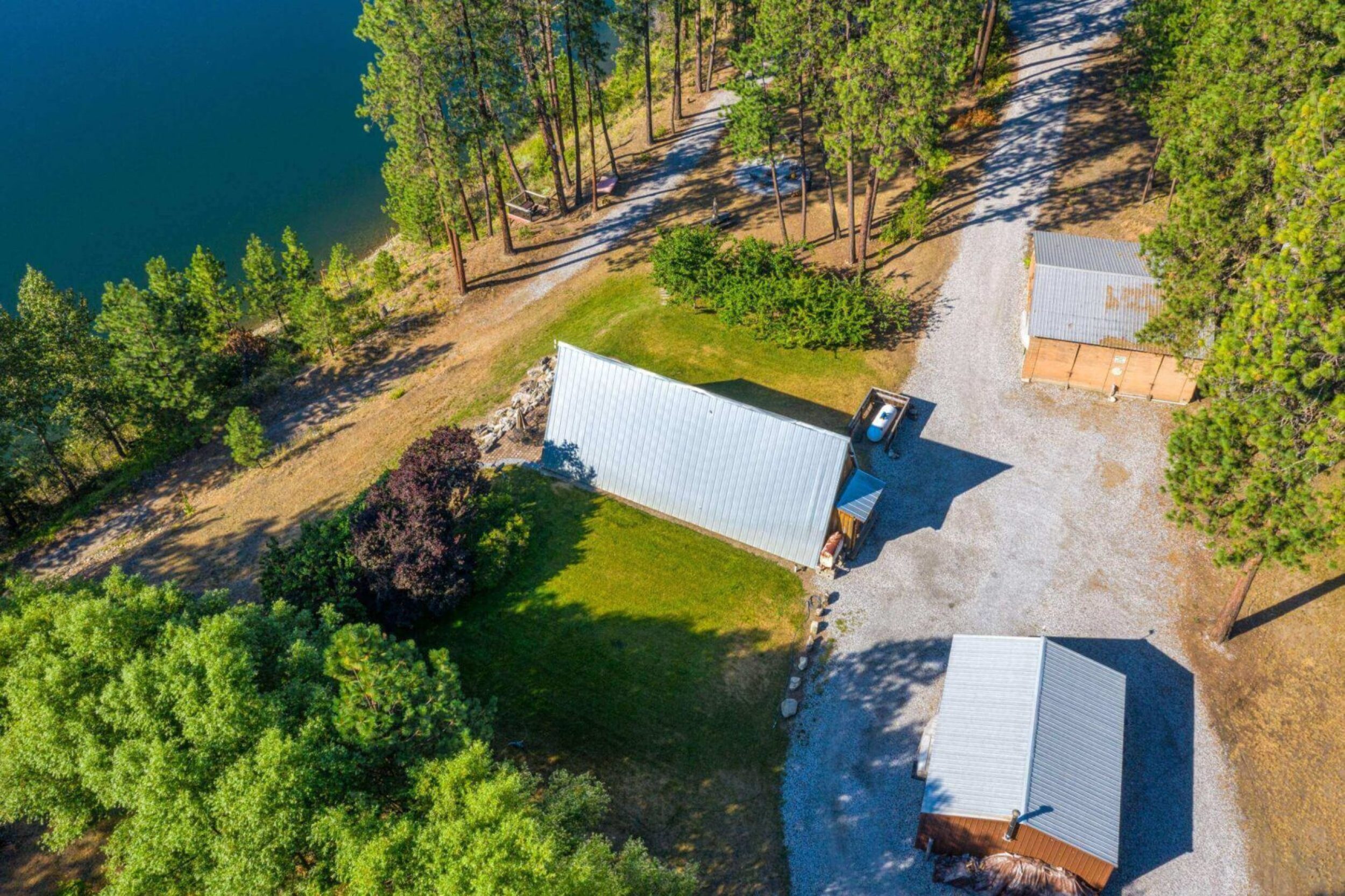 Aerial view of cabins in forested area.