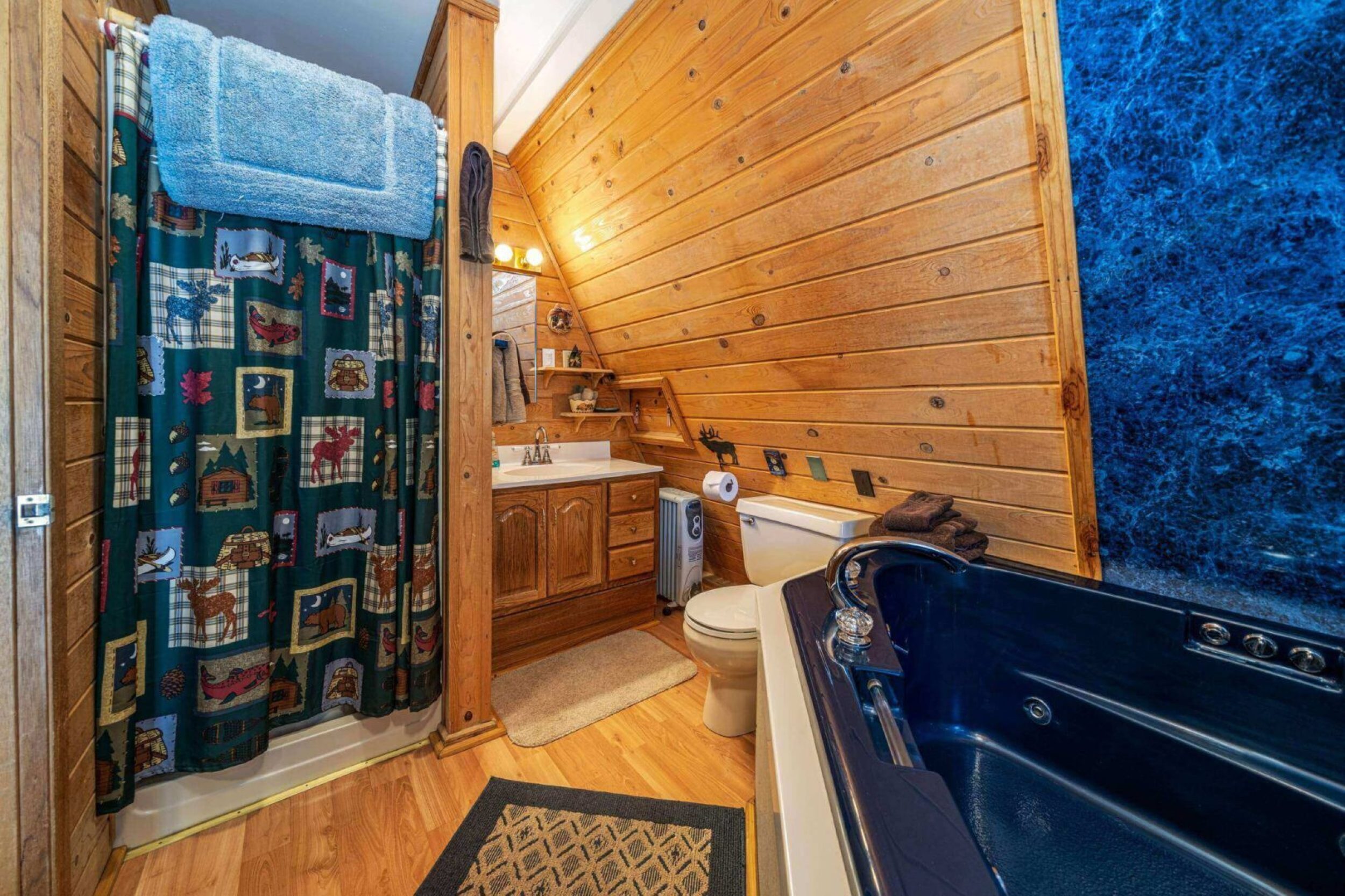 Rustic bathroom with wooden walls and bathtub.