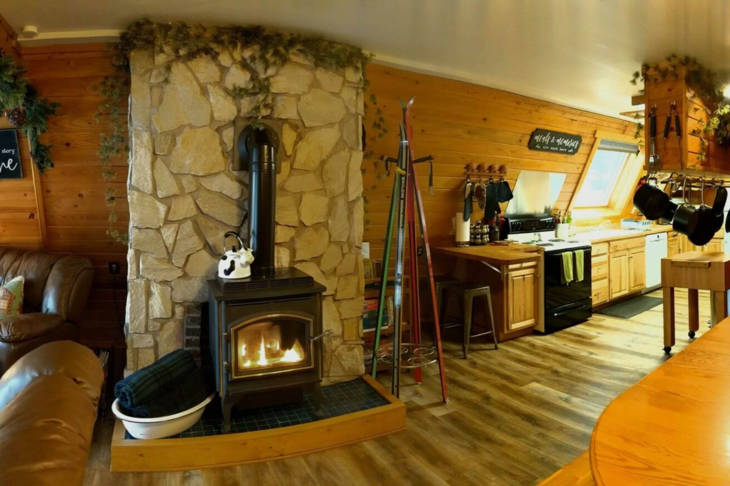 Cozy cabin interior with stone fireplace.