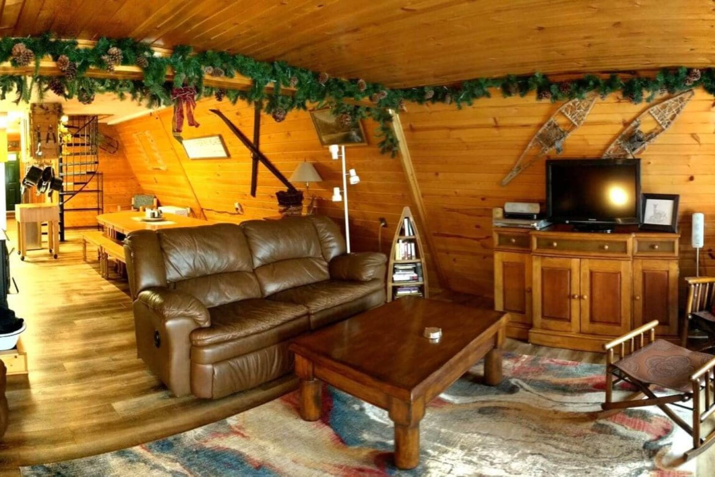 Cozy wooden cabin living room with decorations.
