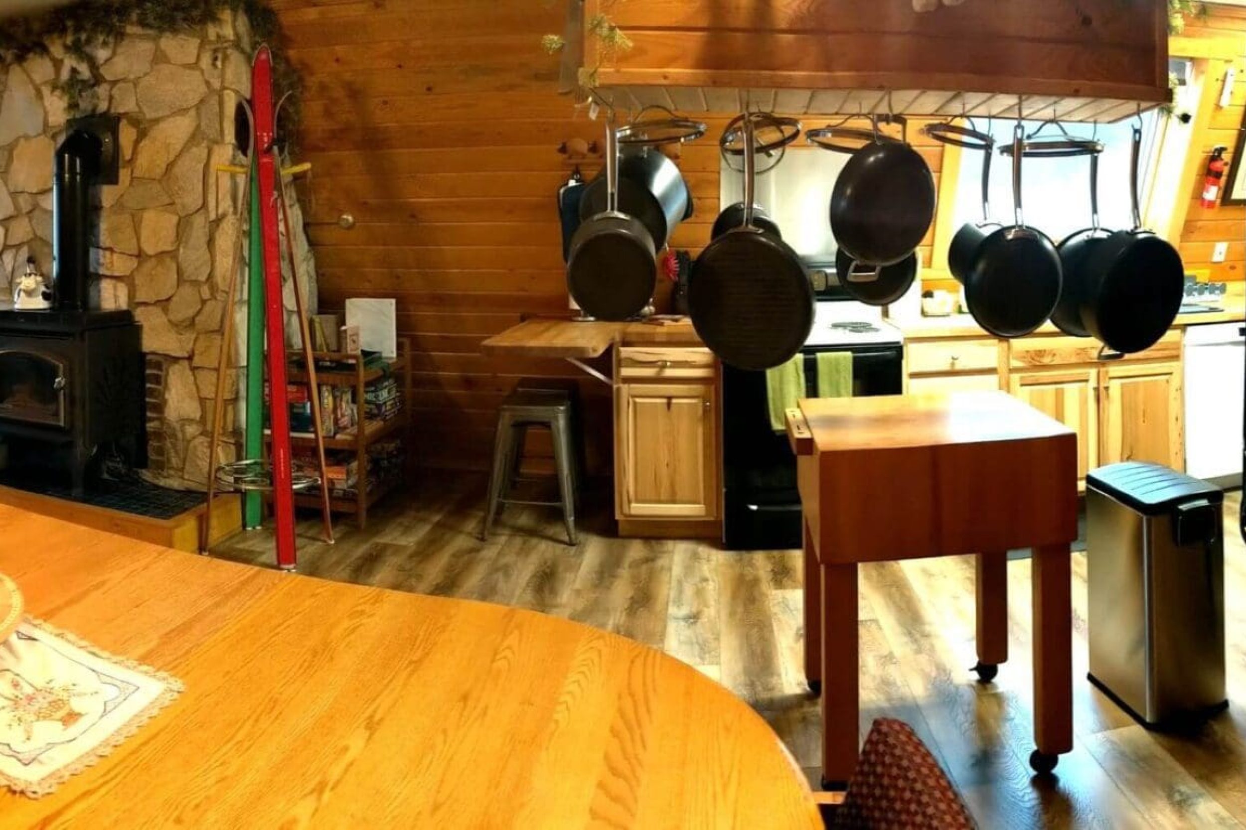 Cozy cabin kitchen with spiral staircase.