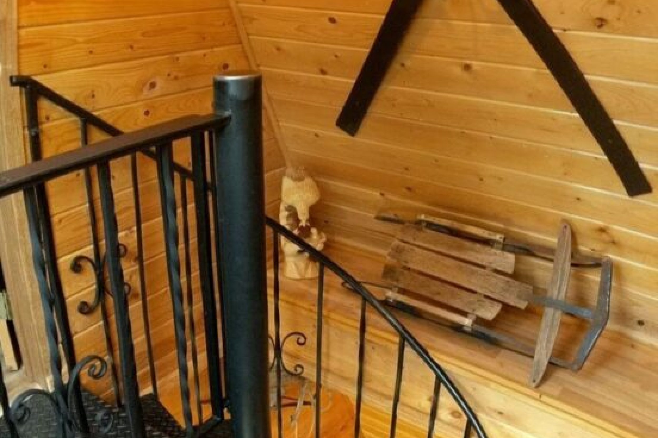 Spiral staircase in rustic wooden interior.